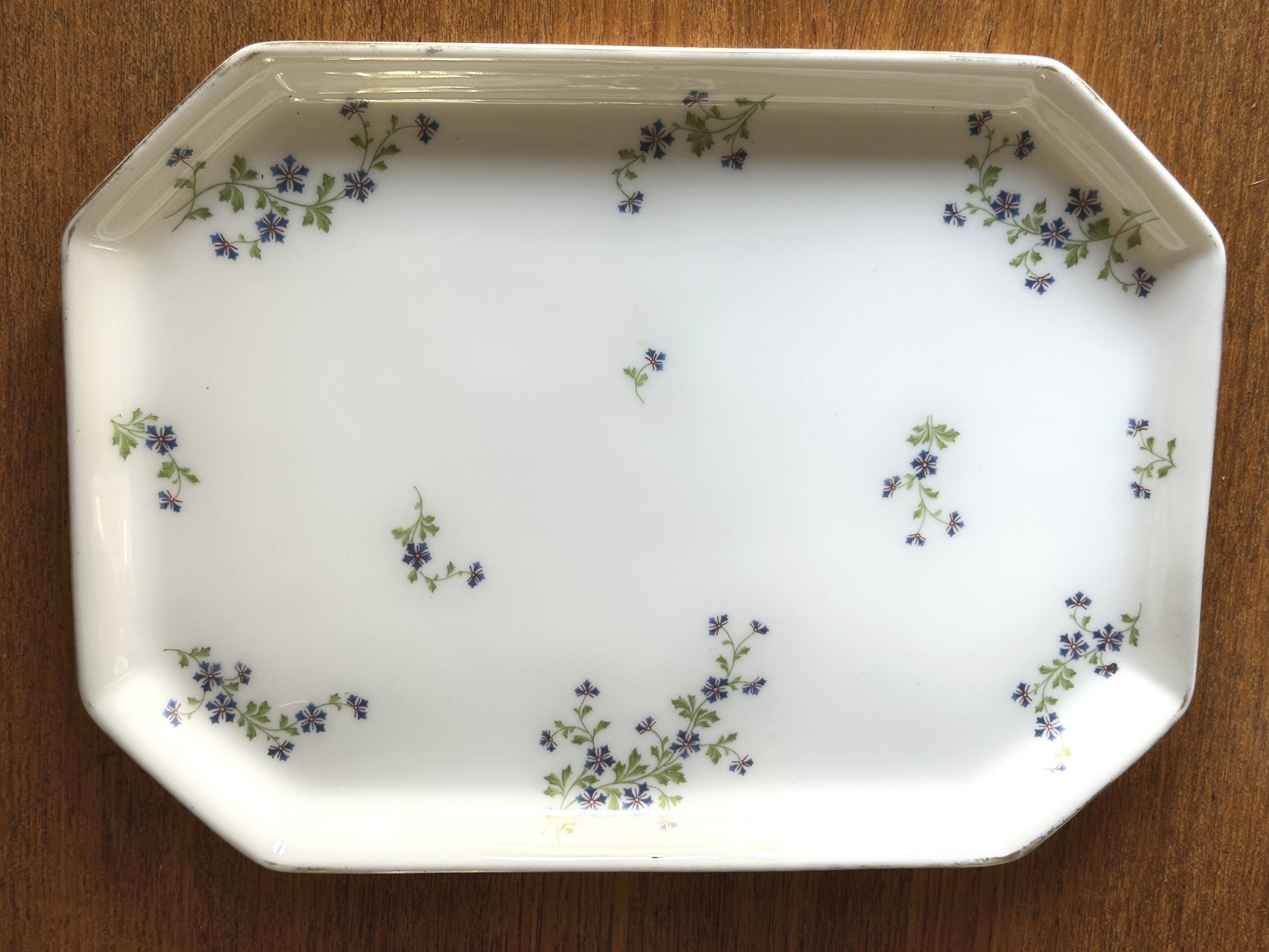 Egg cups on a Limoges porcelain tray by Bernardaud with a barbel decoration.
