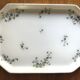 Egg cups on a Limoges porcelain tray by Bernardaud with a barbel decoration.