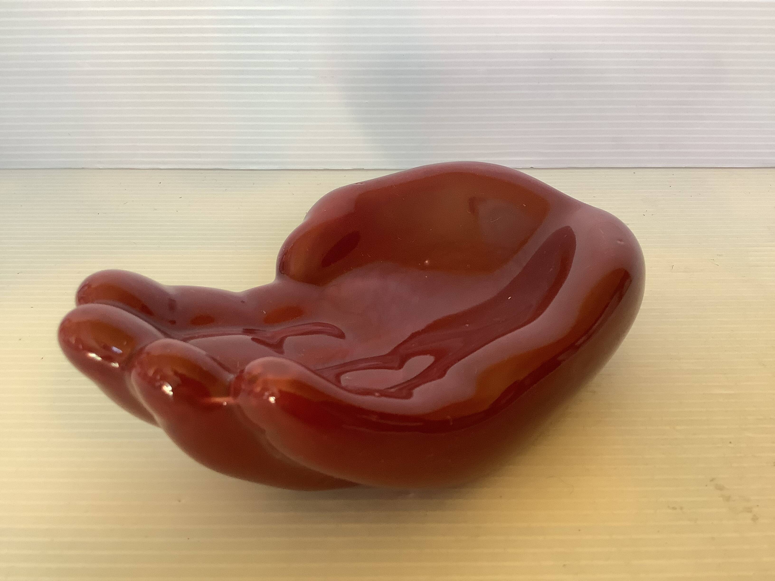 Empty pocket in the shape of a burgundy hand