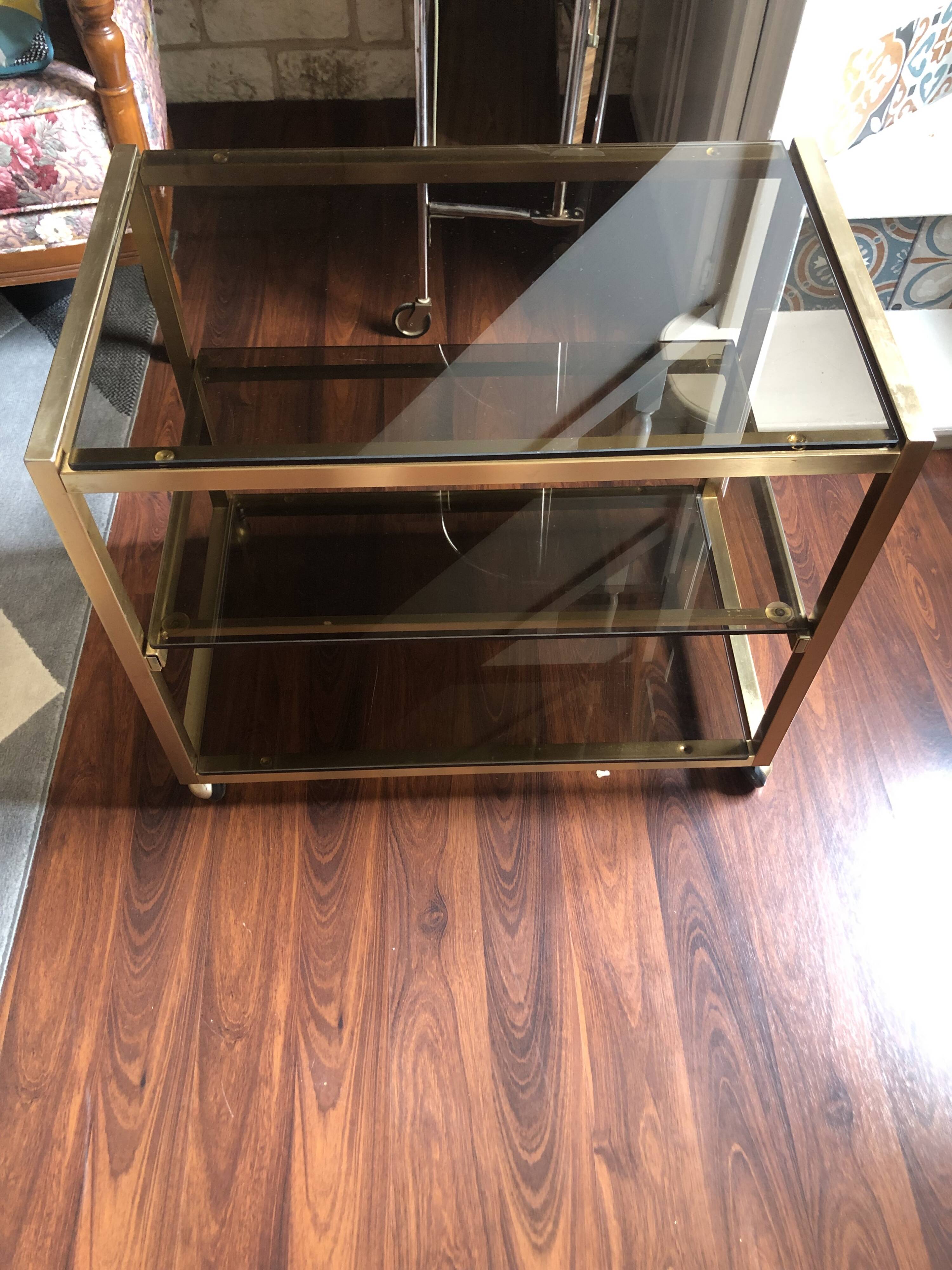 Vintage brass serving trolley with smoked glass trays.