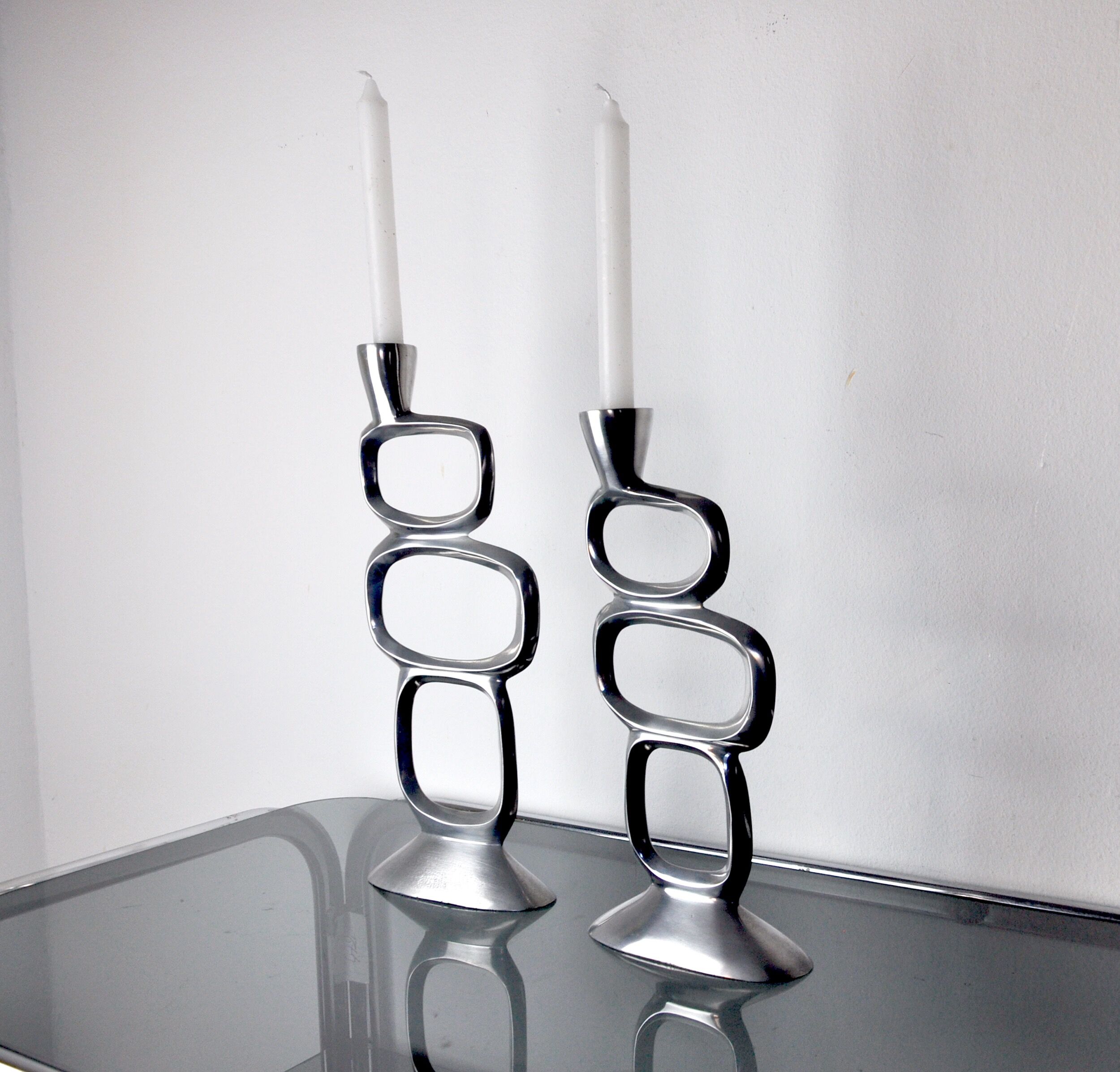 Pair of circle candlesticks by matthew hilton, england, 1980
