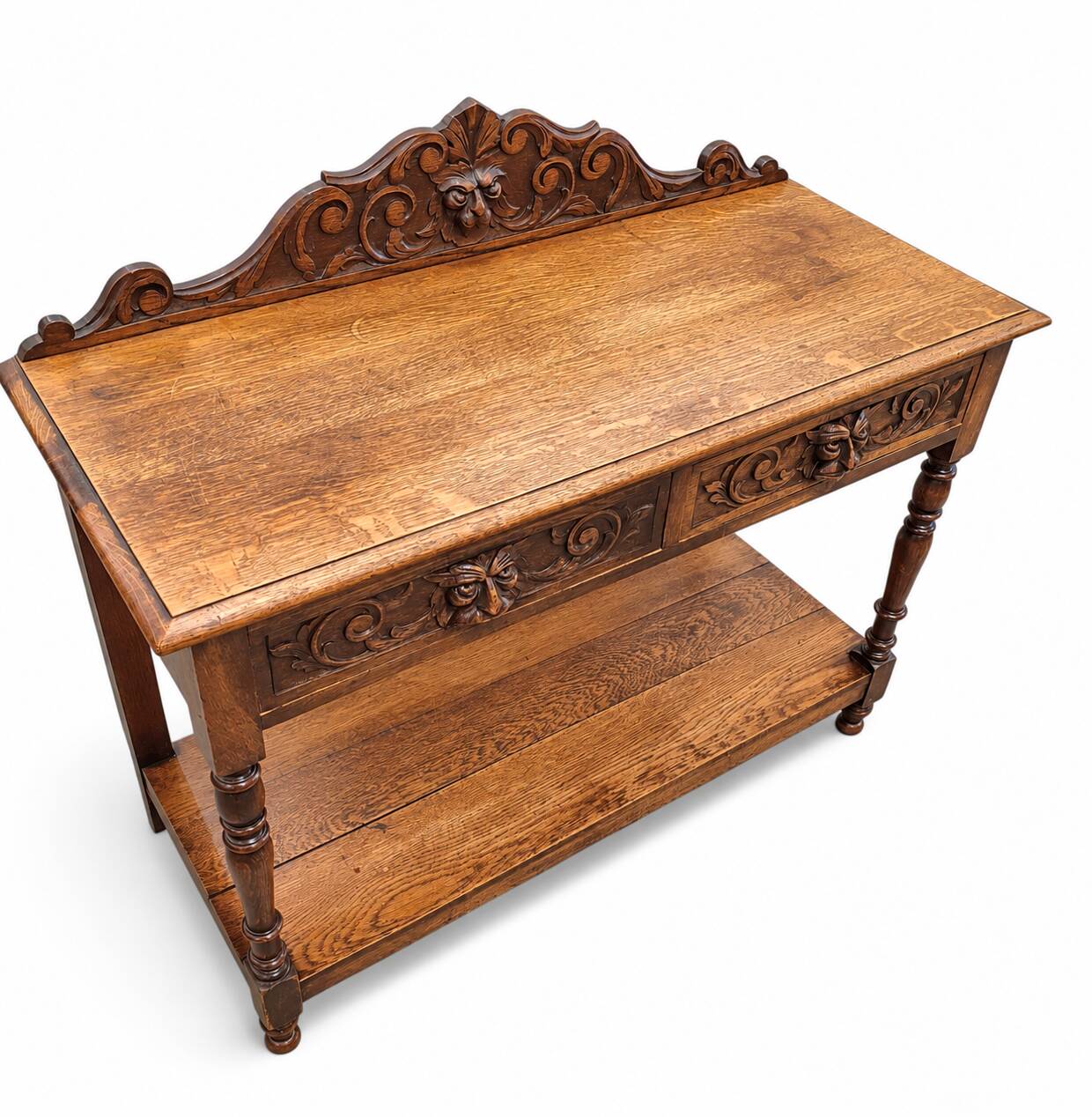 Victorian Gothic Oak side table, decorative carved round 1920. Green Mask decoration