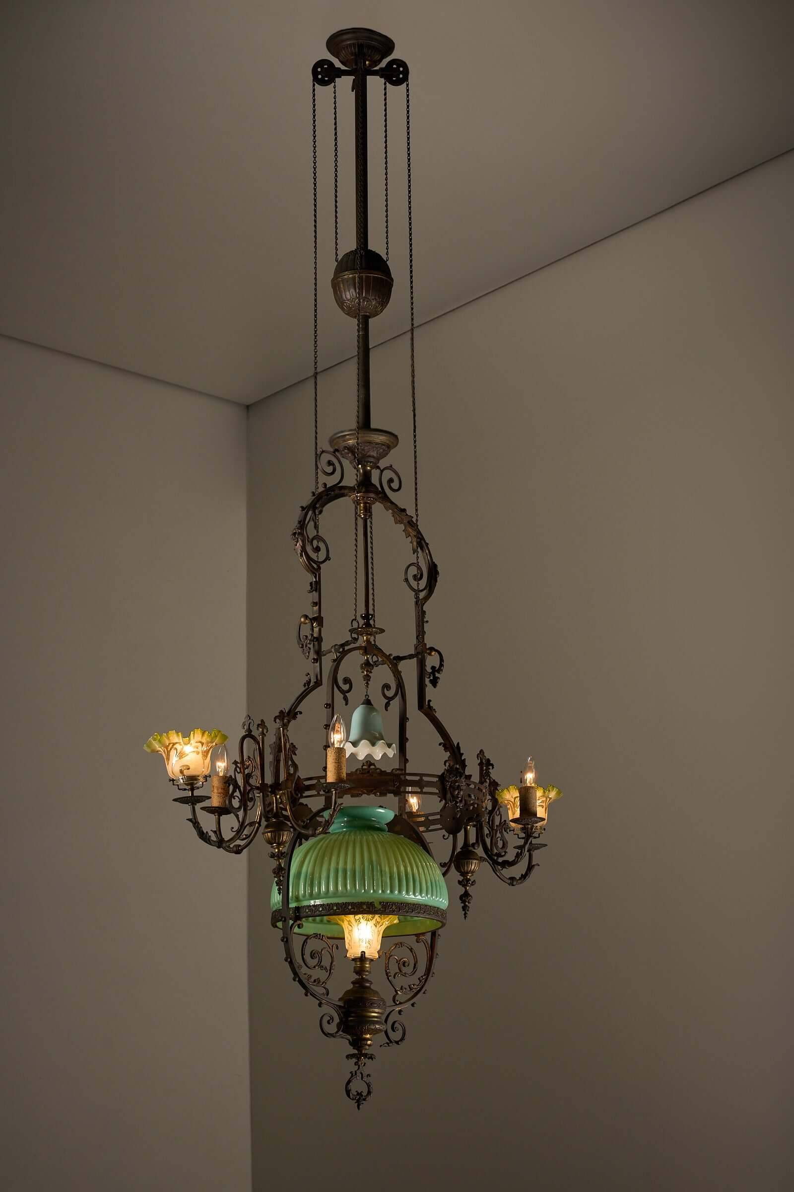 Antique adjustable height chandelier with original glasswork and brass detailing