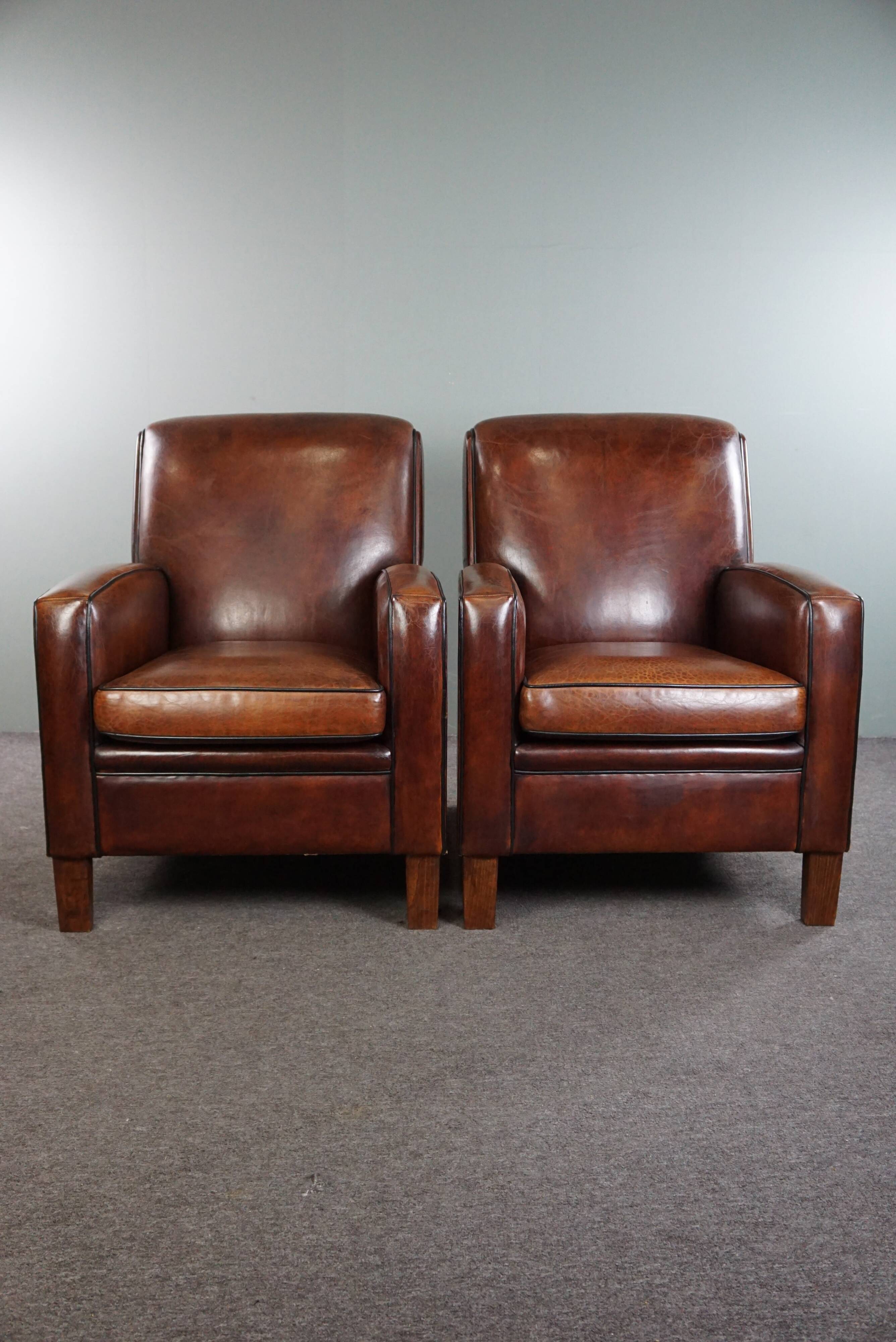 A very beautiful set of 2 Art Deco design armchairs in sheep leather