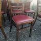 Set of 19 vintage wooden bistro chairs with red faux leather.