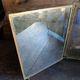 Antique French gilt metal triptych vanity mirror with floral crest