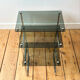 Nest of coffee tables in chrome with smoked glass top.