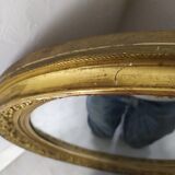 Golden oval mirror