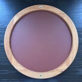 Round mirror in varnished pine