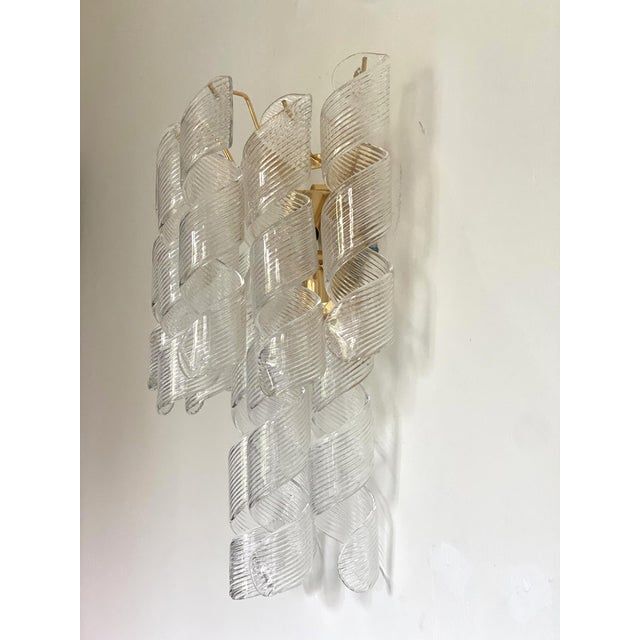 A pair of transparent “ricci” murano glass wall sconces