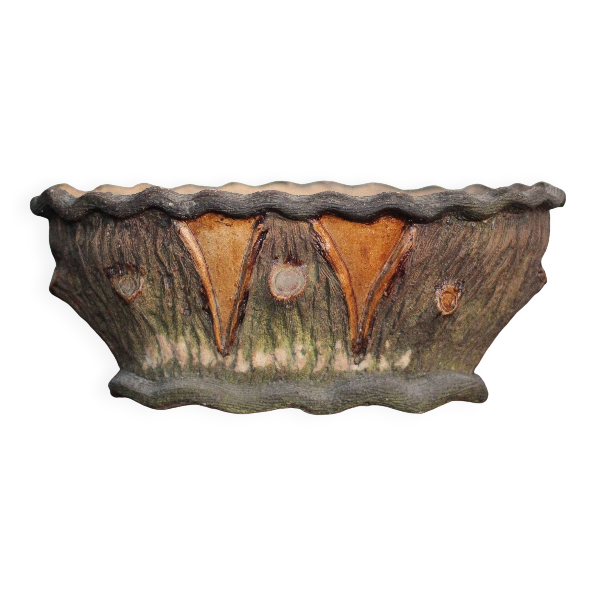 Terracotta planter in a brutalist style resembling a tree trunk, pot cover, countryside.