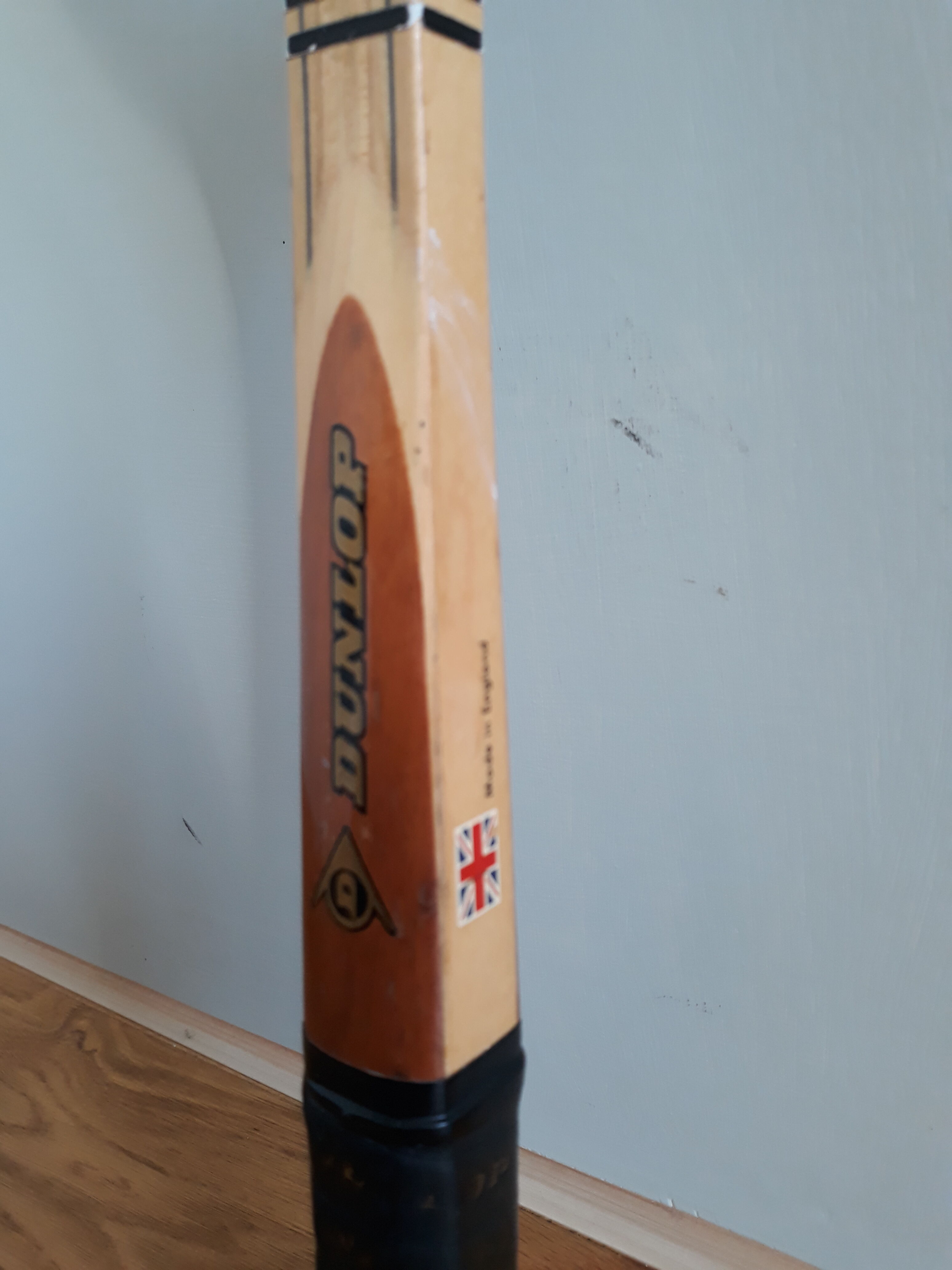 Wooden Dunlop tennis racket with its cover