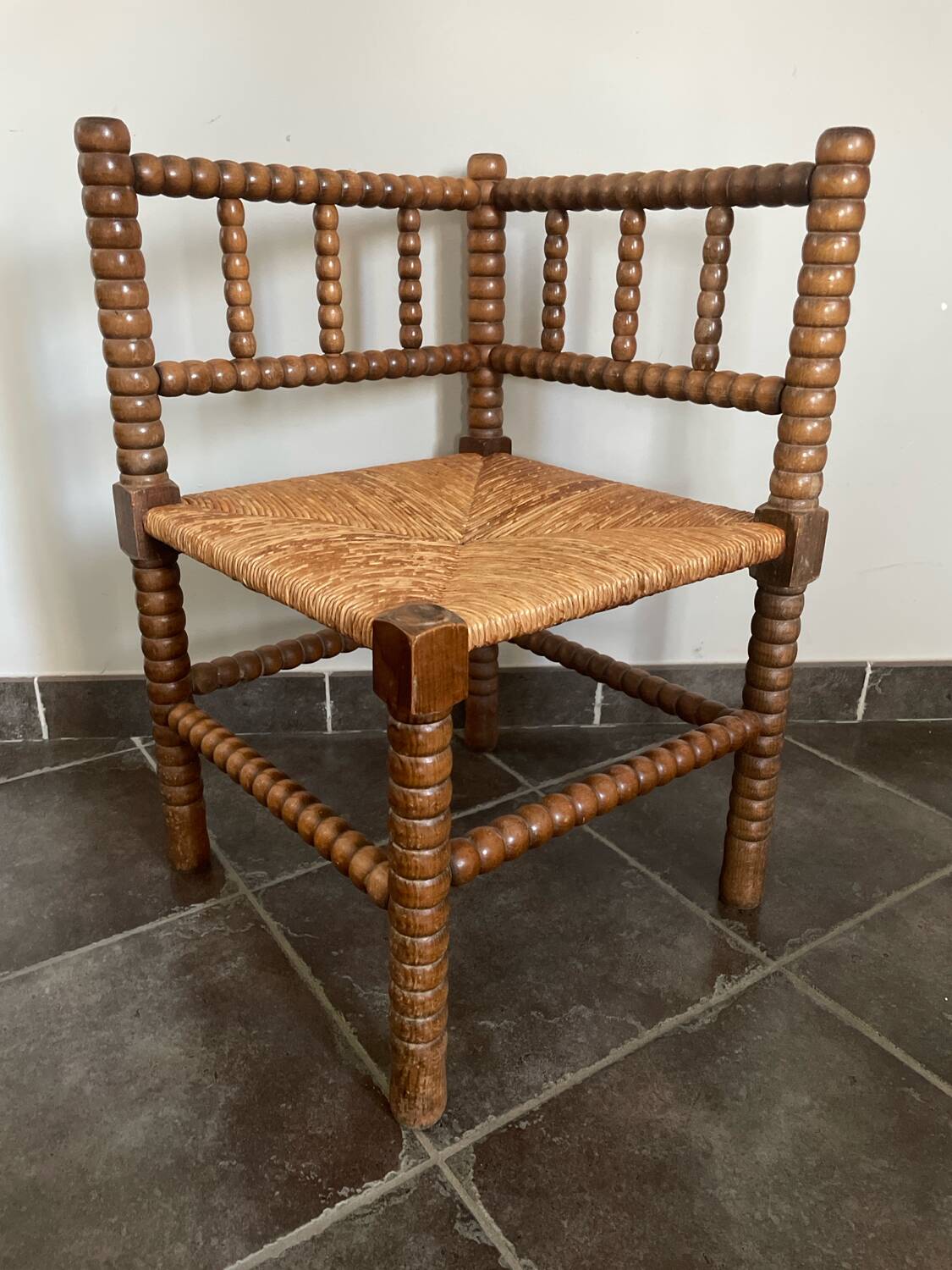Old armchair, corner chair, made of wood and straw