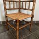 Old armchair, corner chair, made of wood and straw