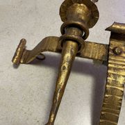 Spanish brutalist wall light in gilded wrought iron.