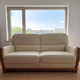 Beige leather sofa with solid wood frame