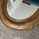 Louis Philippe 19th century oval gilded mirror in wood and stucco