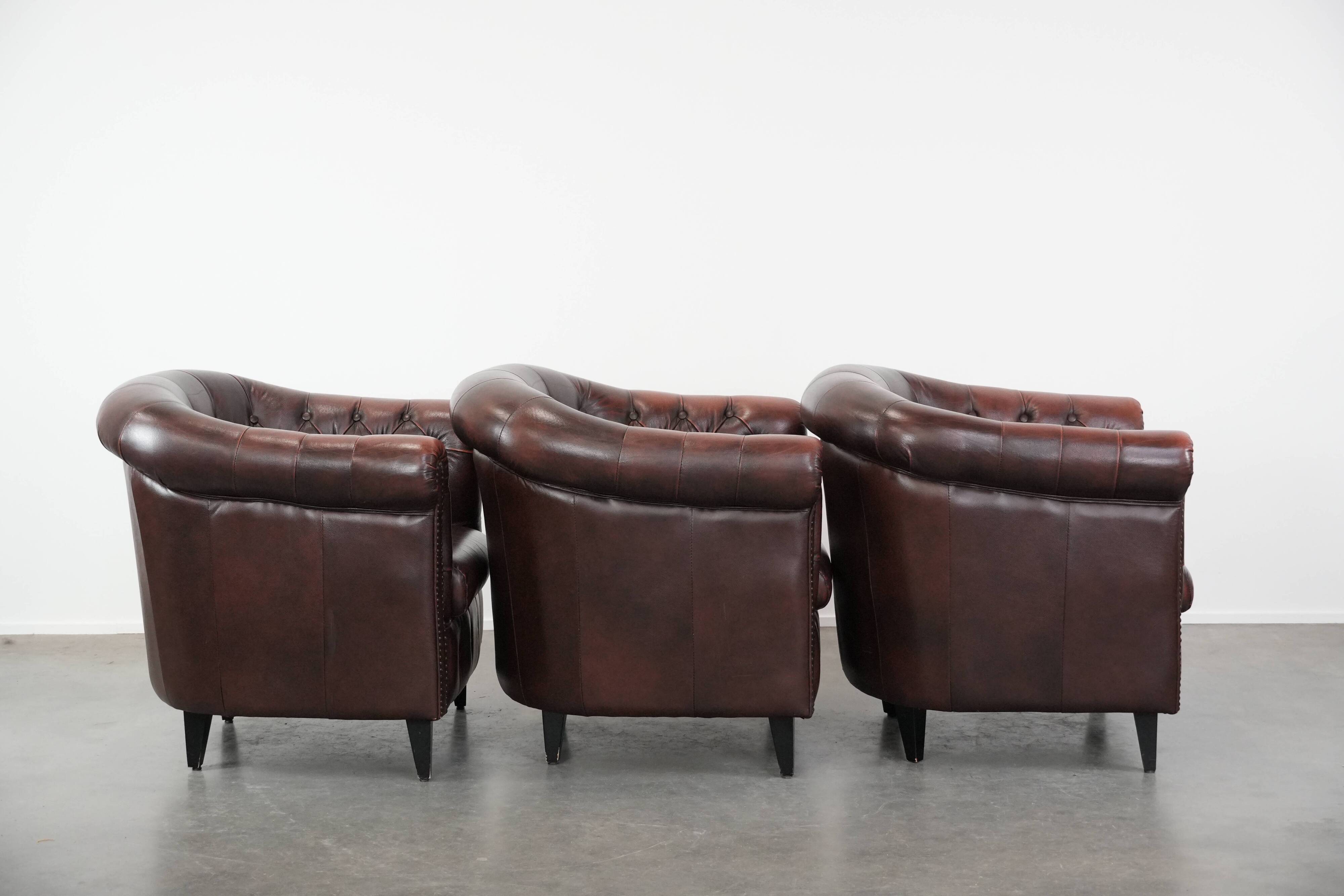 Set of three classic English-style Chesterfield cowhide  club armchairs