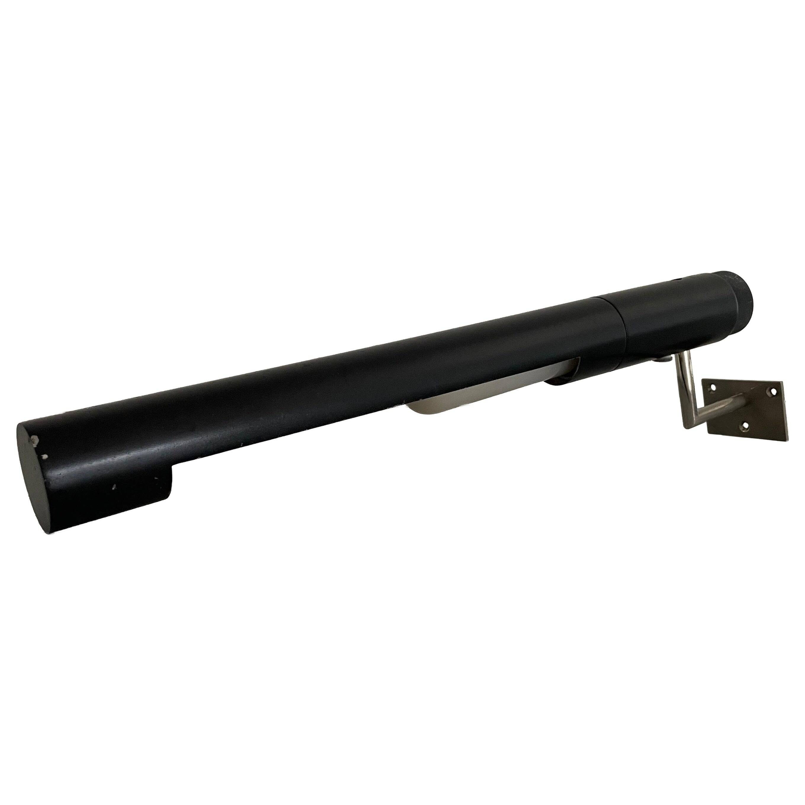 Minimalist black metal wall light with a cylindrical design, 1960s, Germany.