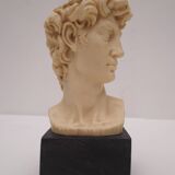 Small glass globe on base housing a figurine of “david”