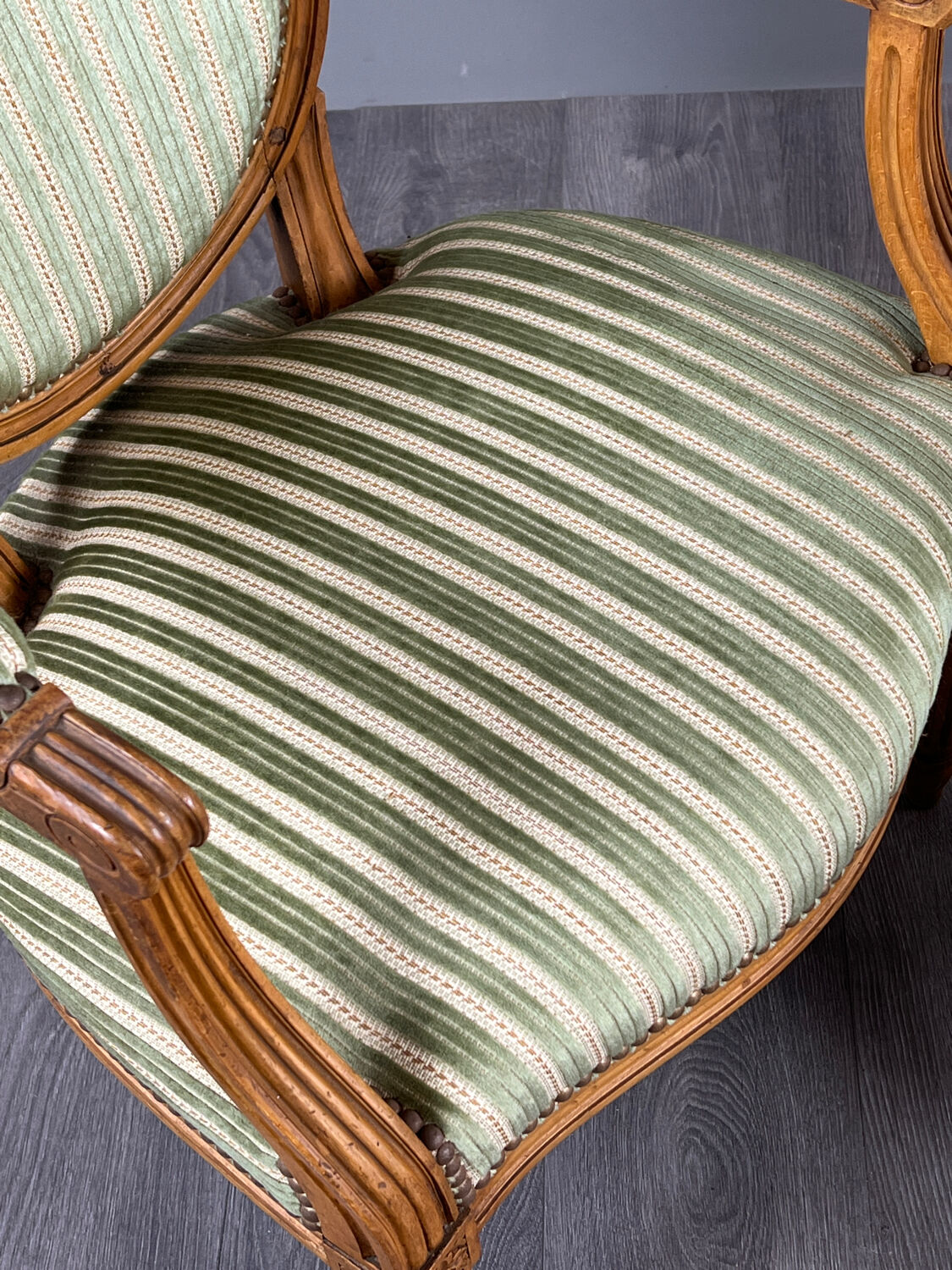 Pair of Louis XVI style armchairs in striped green fabric, 20th century.