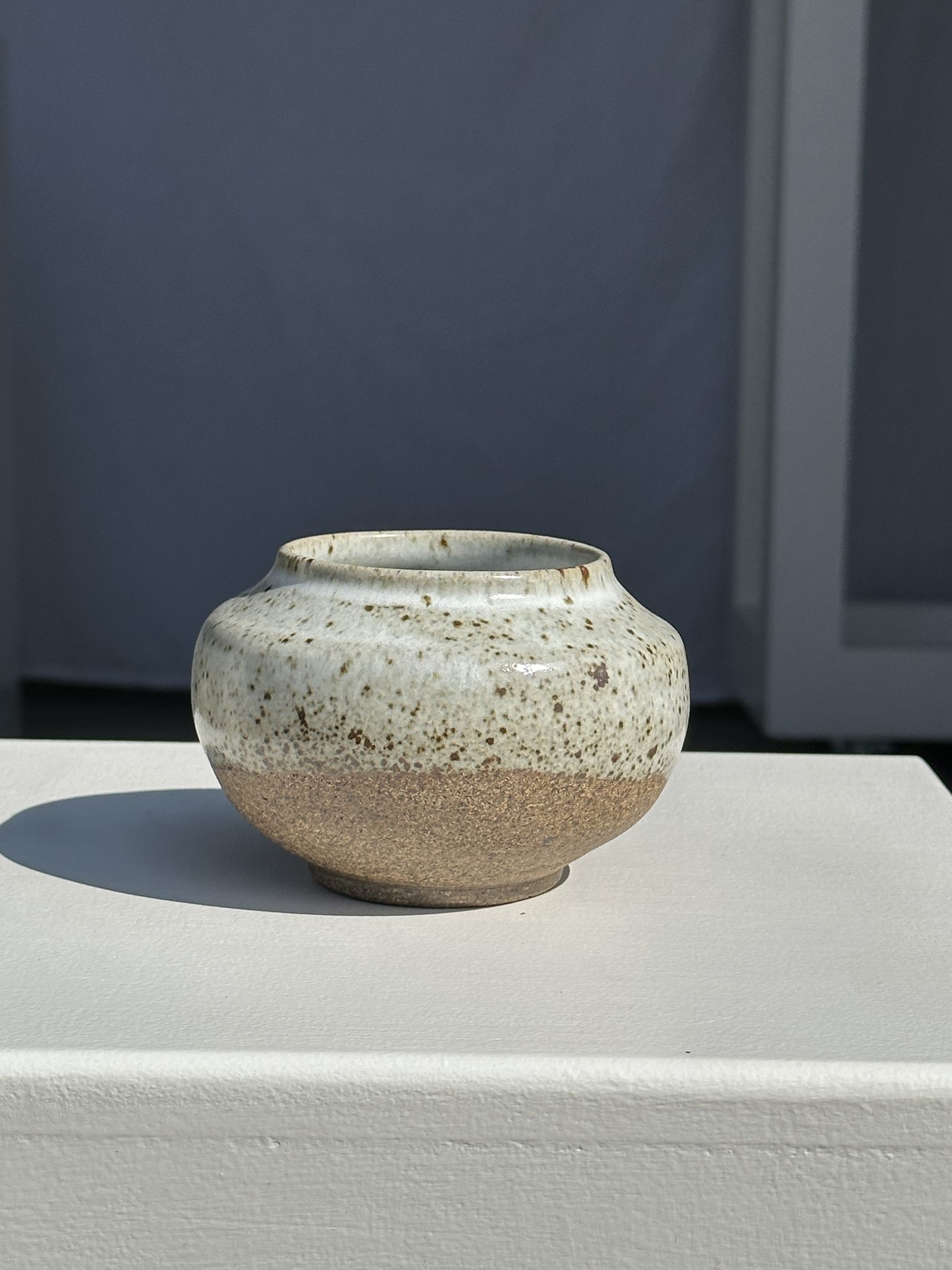 Small white ball vase tight neck in glazed speckled ceramic