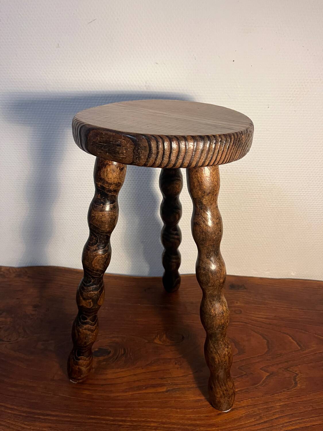 Round wooden tripod stool
