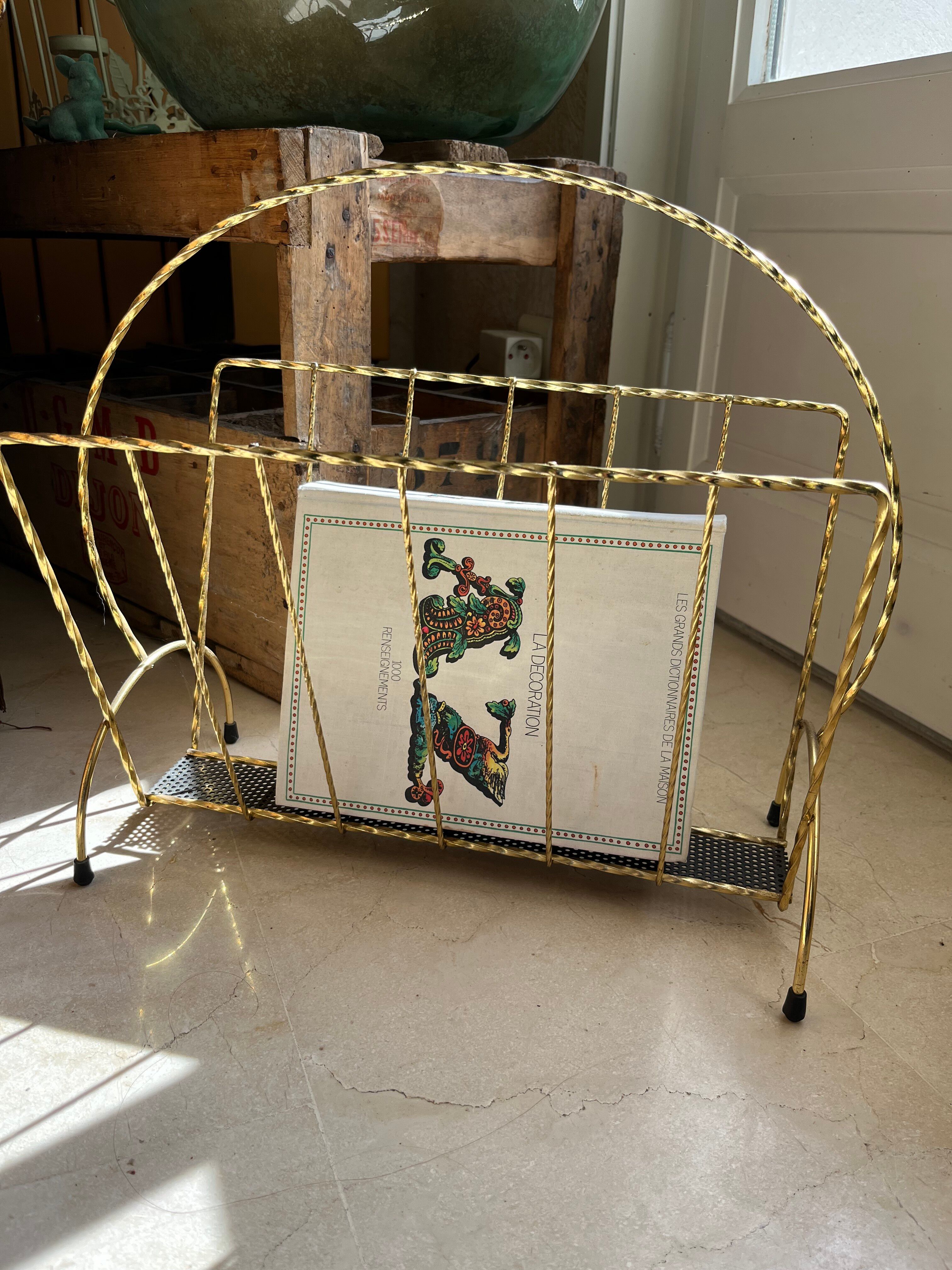 Vintage gold metal magazine rack from the 1960s.