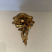 Antique wall-mounted console in gilded wood in rococo style.