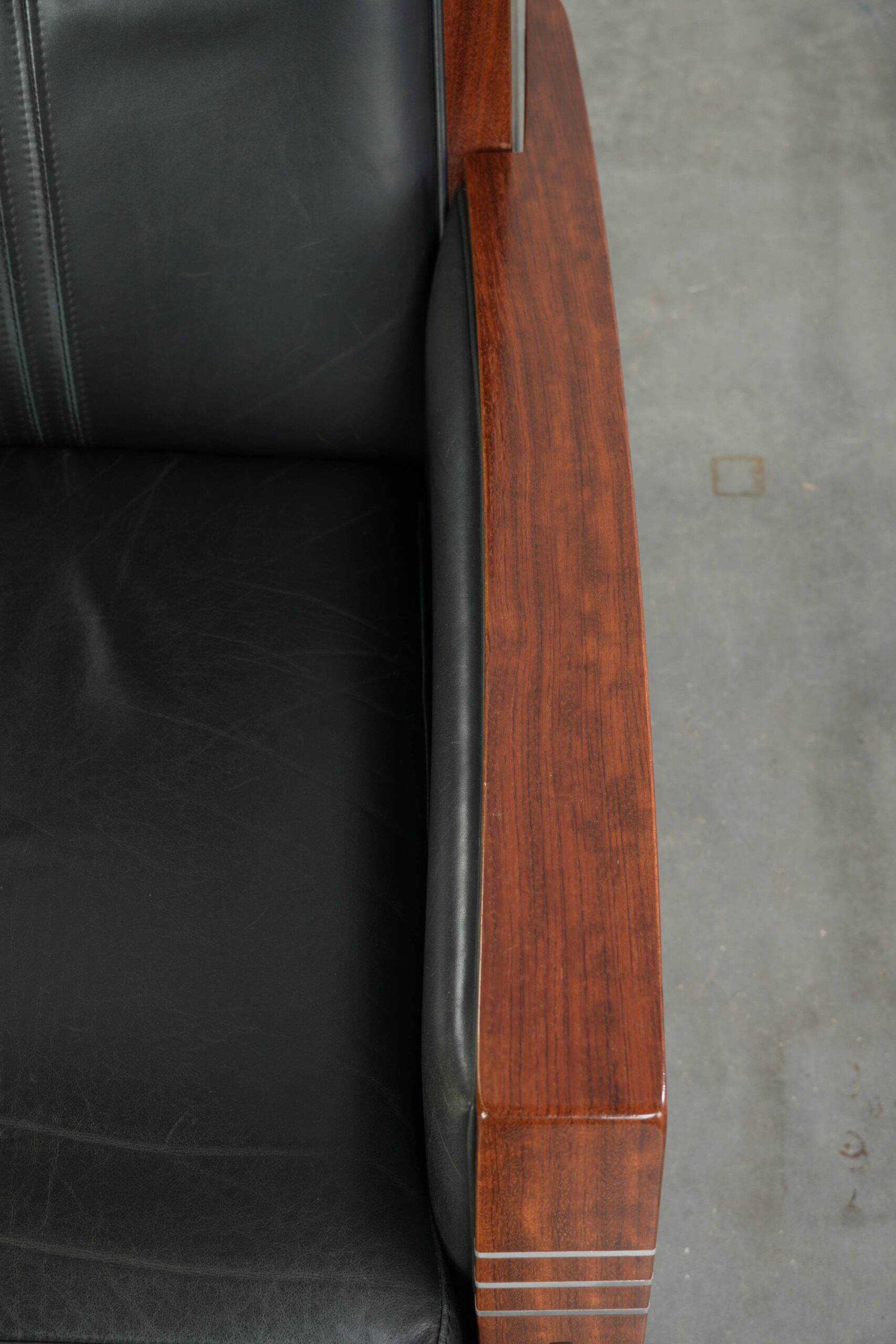 Electrically adjustable Art Deco design recliner with black cowhide leather