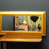 Large mirror in a golden decorative frame