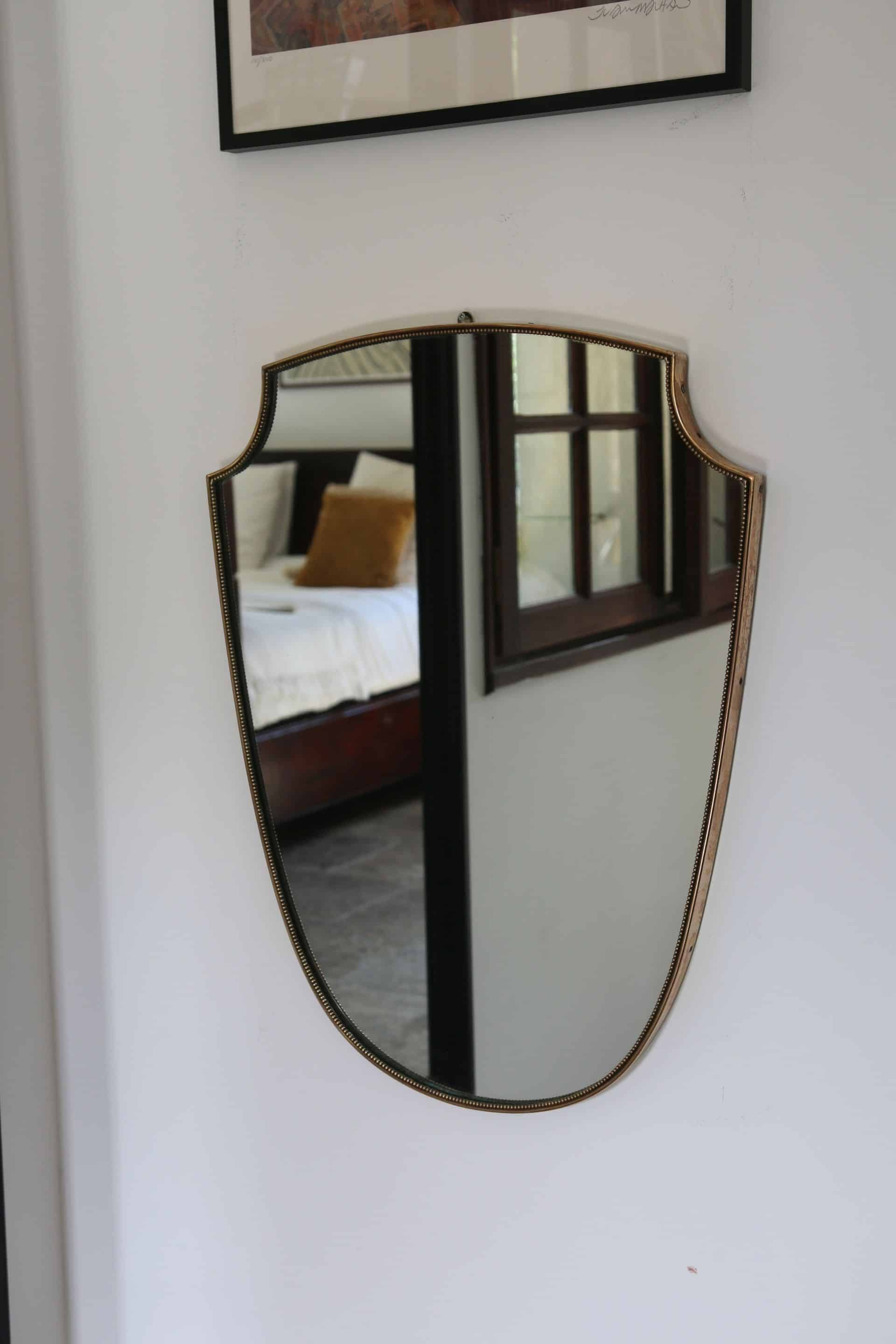 Brass mirror with crest, bead frieze, Italian design style.