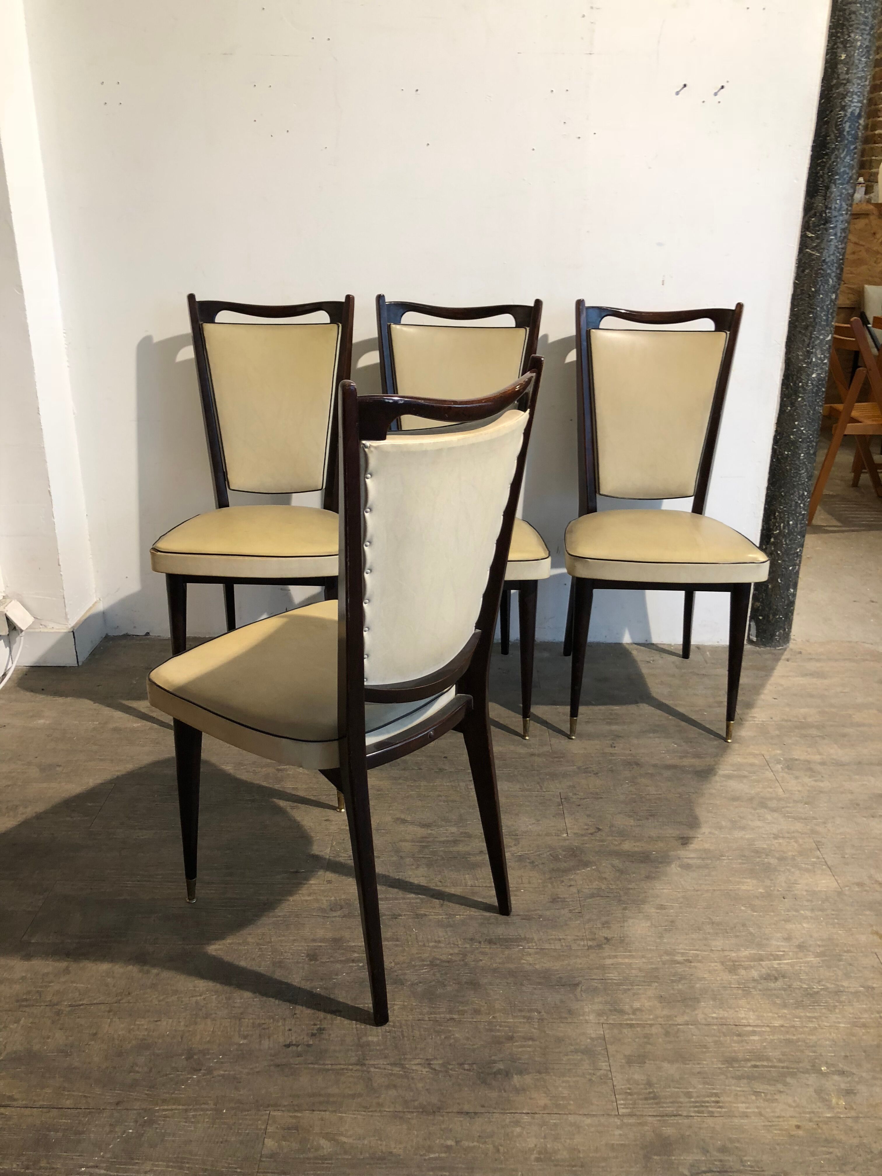 Four white leatherette chairs