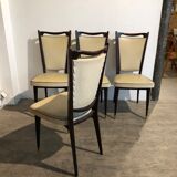 Four white leatherette chairs
