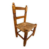 Old, rustic children's chair, small wooden and straw chair.
