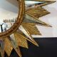 Golden sunburst mirror with wooden rays - 1950s