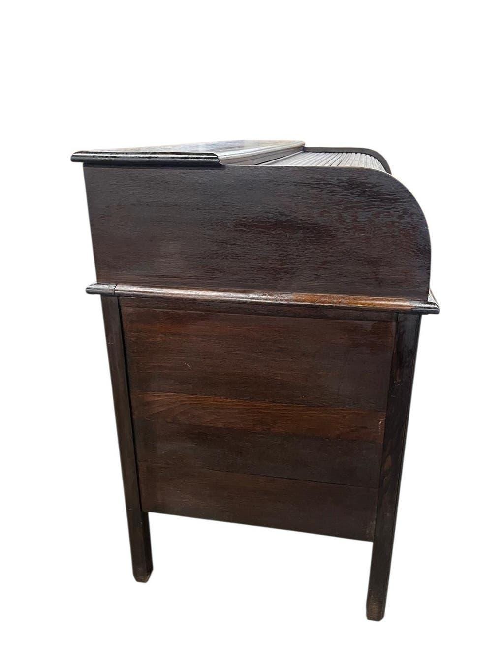 Vintage American wooden desk with a roll-top.