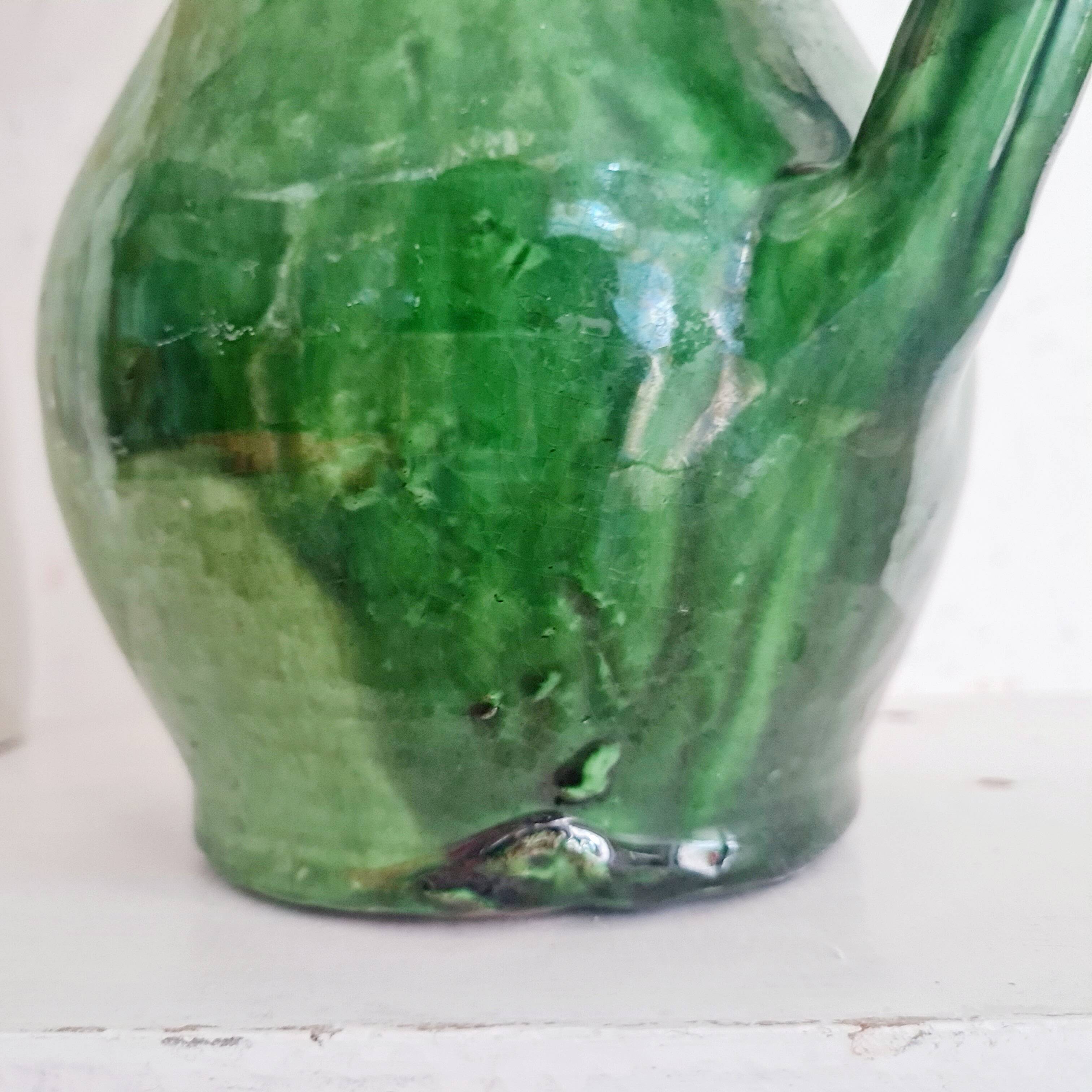 Antique green pitcher in painted terracotta