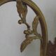 Simple wall sconce in French Art Nouveau bronze with a white glass shade featuring patterns.