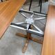 Modular round teak table with central base by Osvaldo Borsani.