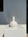 Handcrafted drop-shaped soliflore vase in terracotta, painted white, h:20 d:15.