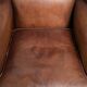 Subtle dark brown sheepskin wingback armchair with a timeless look subtle