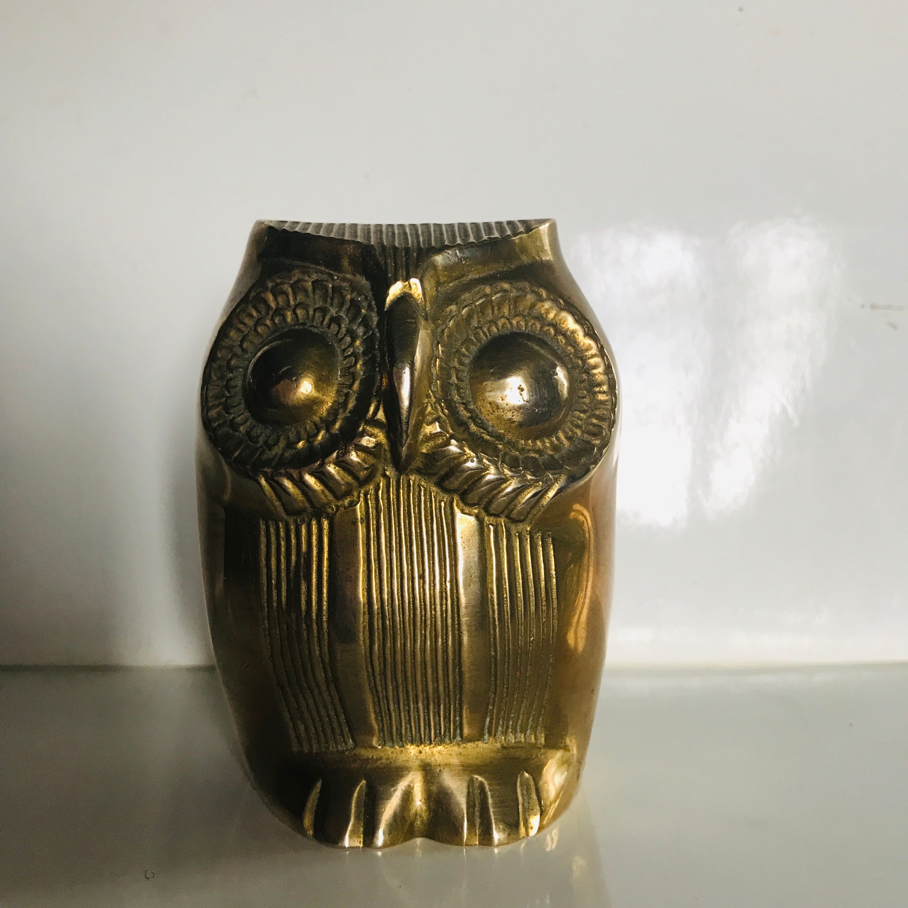 Brass owl wears incense