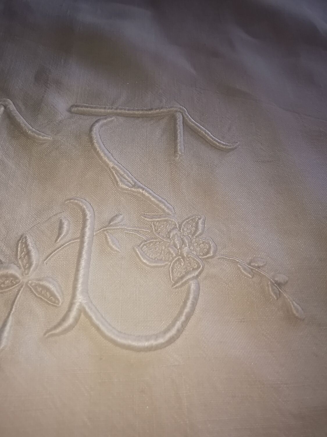 Antique embroidered linen sheet with a monogram.