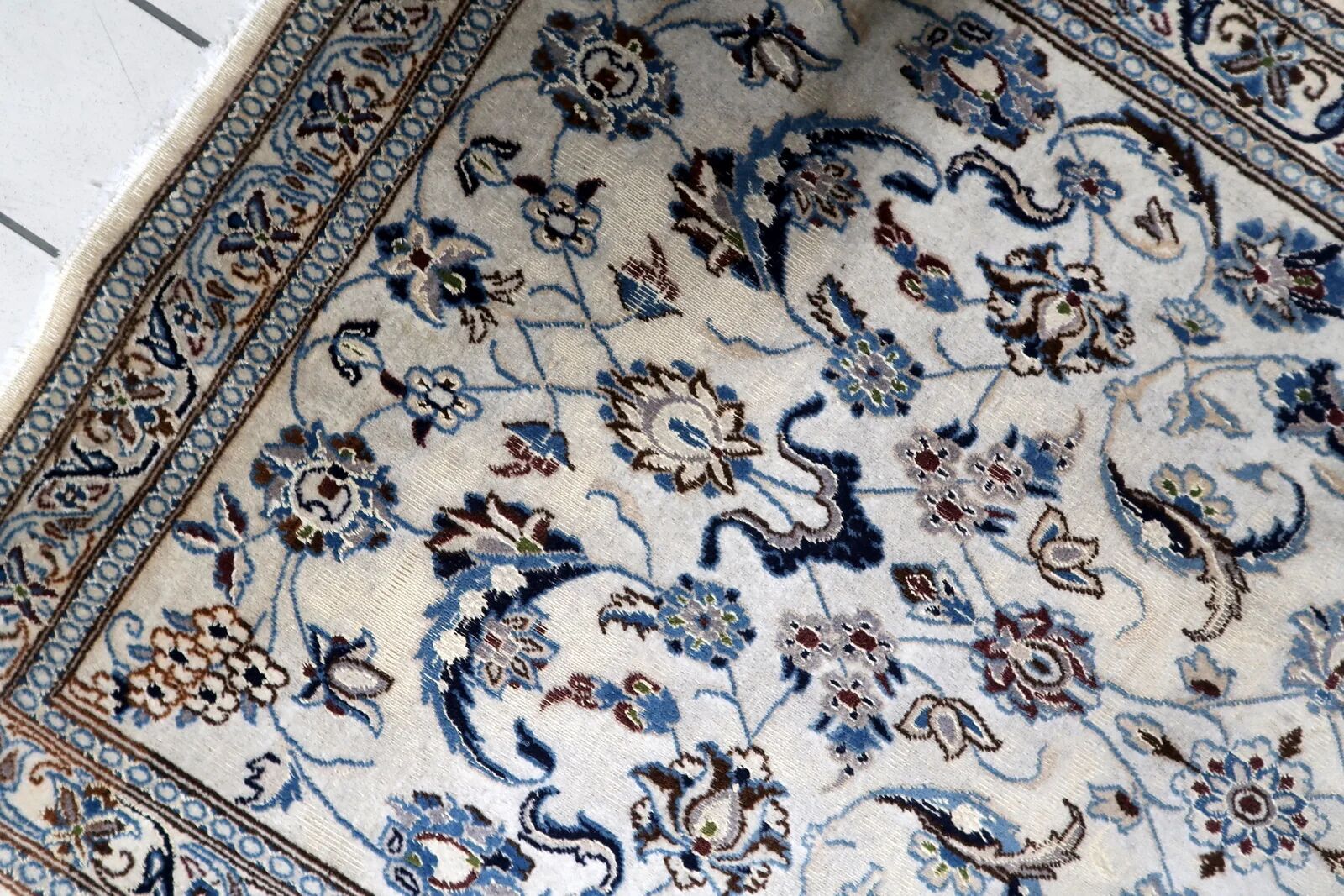 1950s hand-knotted wool rug with silk highlights, ivory and blue, 118 × 200 cm