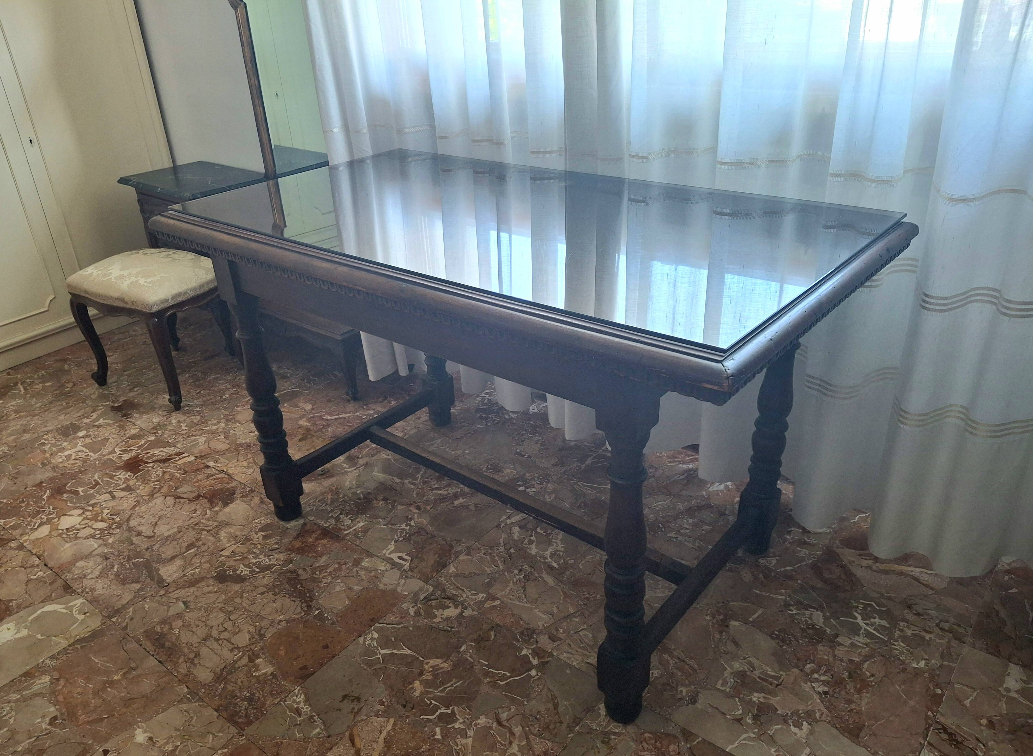 1960s Italian wooden table with a glass top.