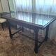 1960s Italian wooden table with a glass top.