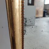 Long wooden mirror and gilded stucco with pearl rays H: 2m45 L: 40cm