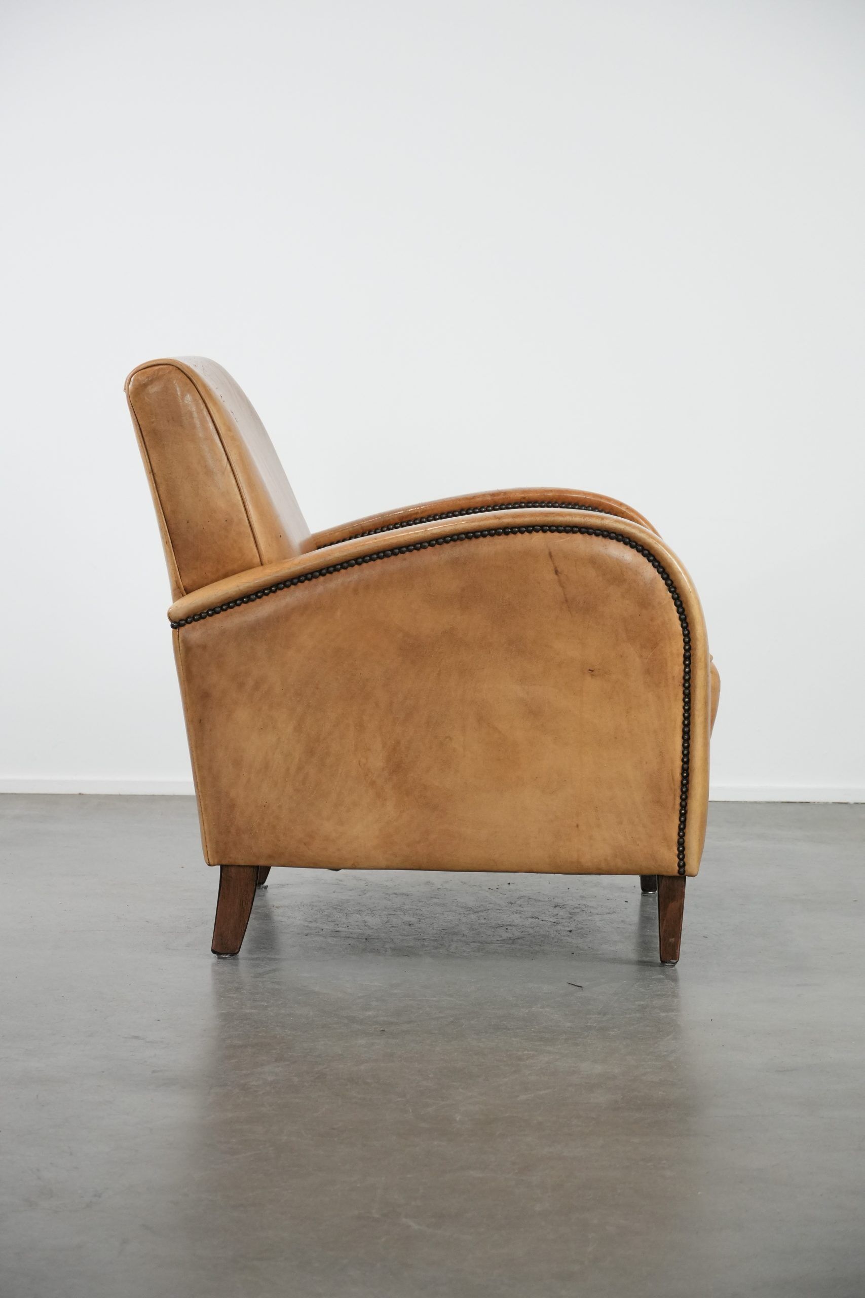 Luxury armchair made of cowhide leather with a beautiful warm colour scheme