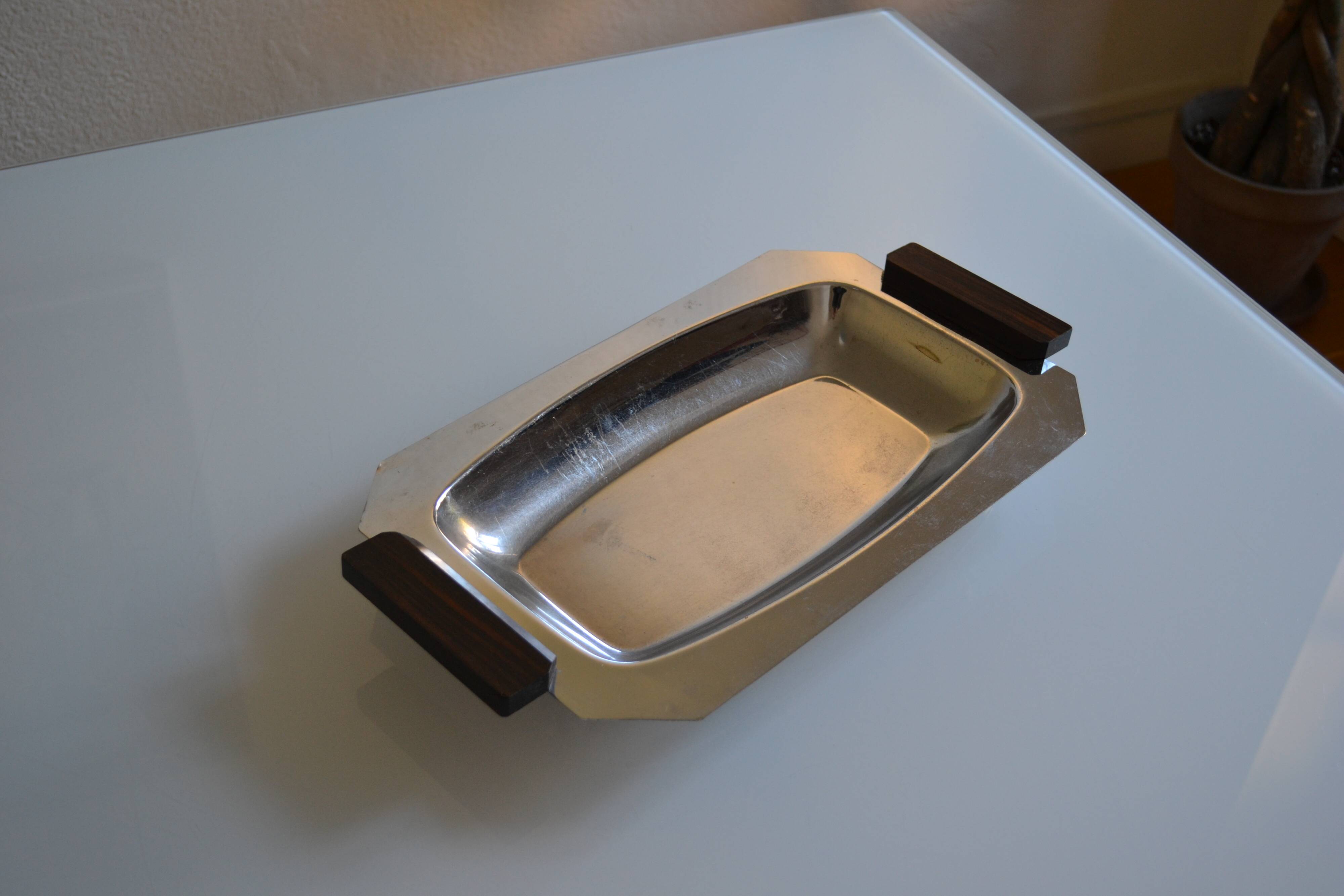 Art Deco serving dish in chrome metal with ebony handles.